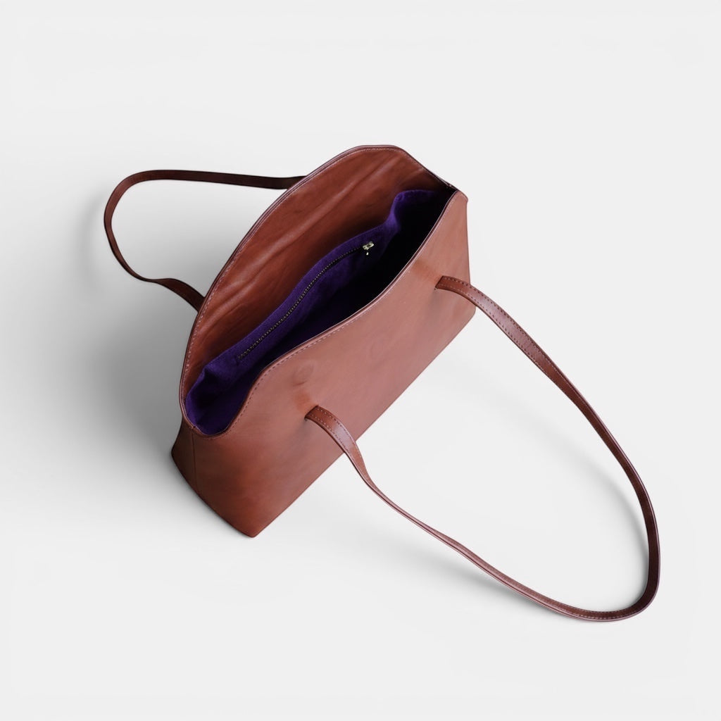 SELENE AMAS Juliet Bag in chestnut leather with purple lining and top handles.