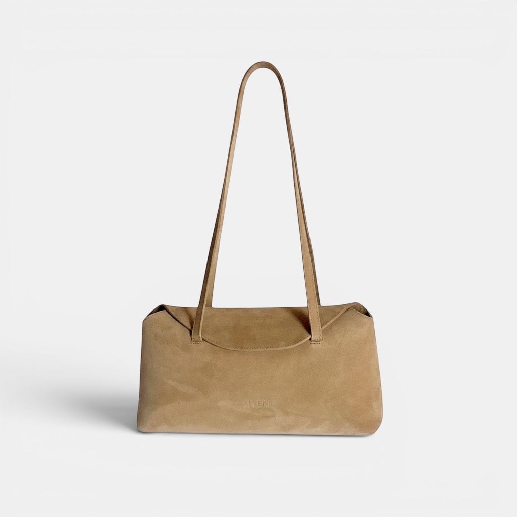 SELENE AMAS Juliette sand suede shoulder bag with thin straps and signature flap closure. Lined in amethyst fabric.